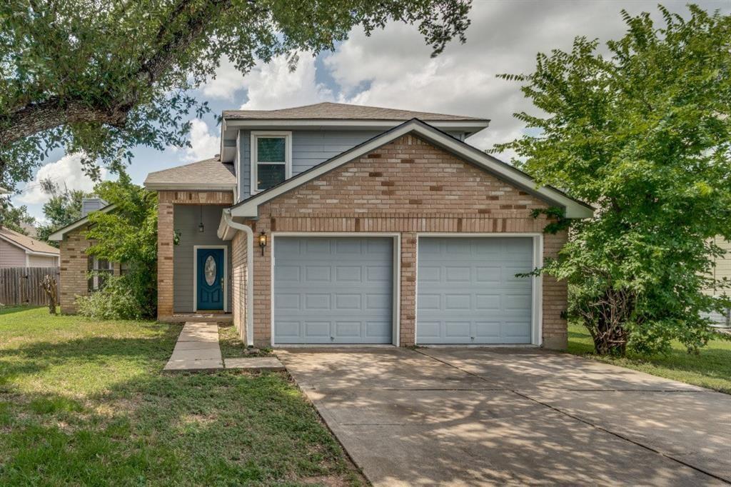 A classic brick and siding home features a welcom