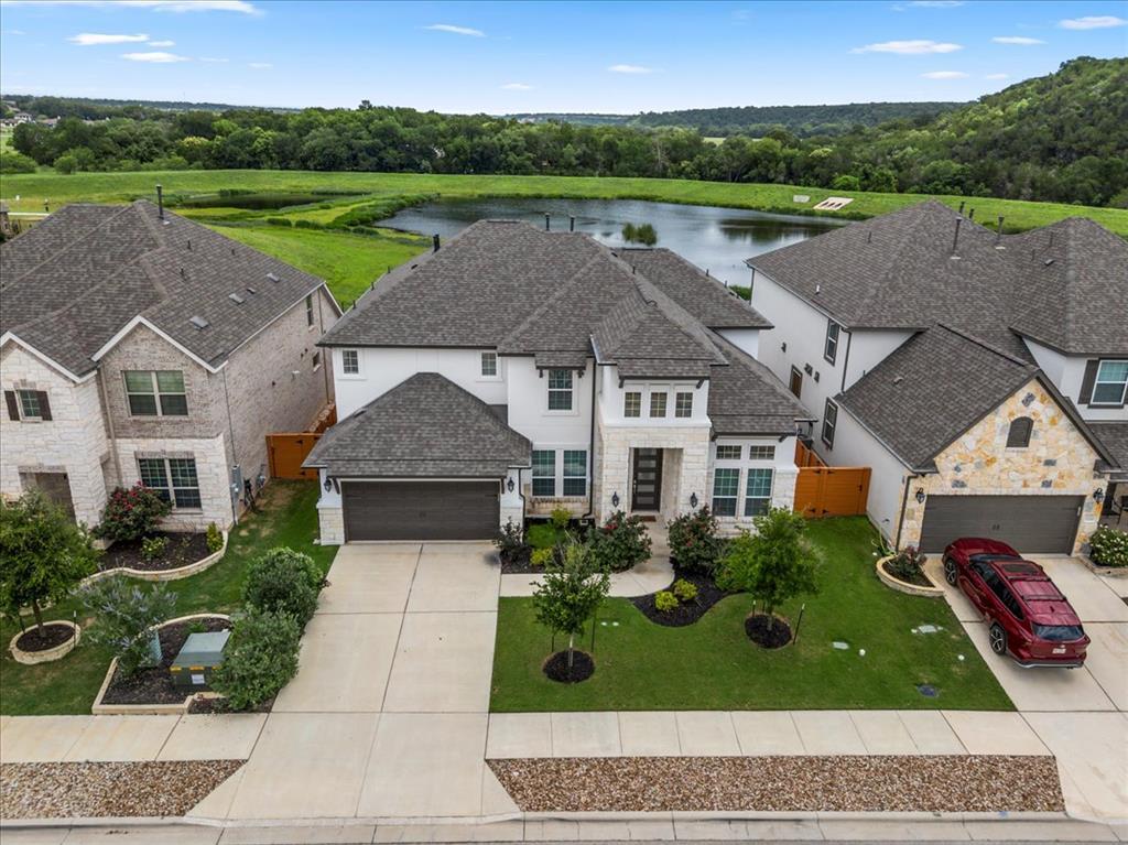 Perched on a serene lot with a backyard lake view