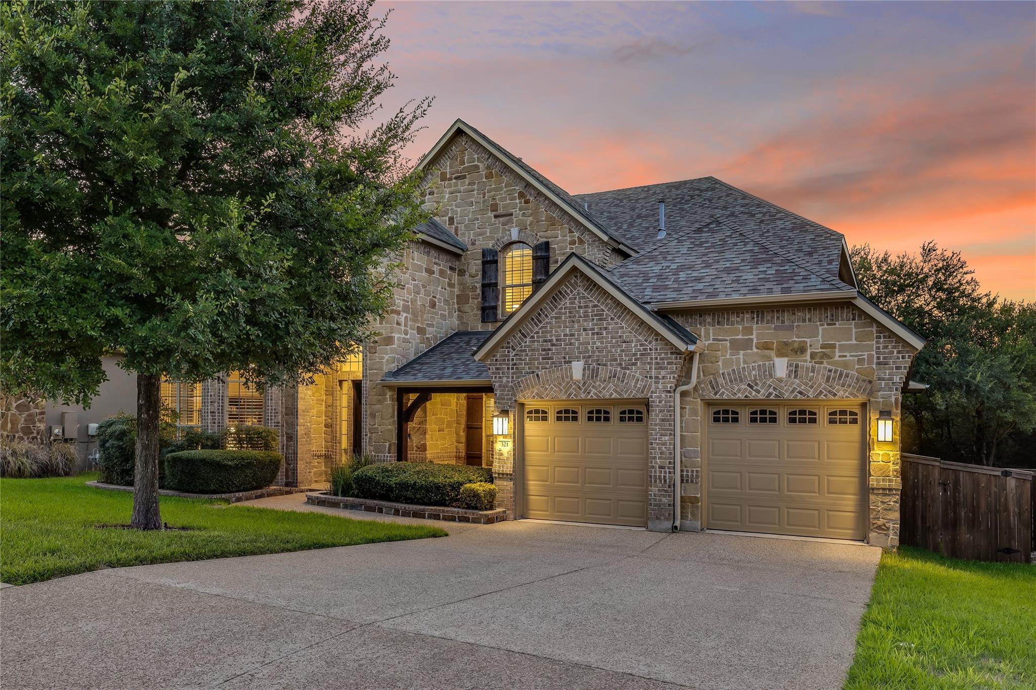 Stone and brick facade home with a spacious drive