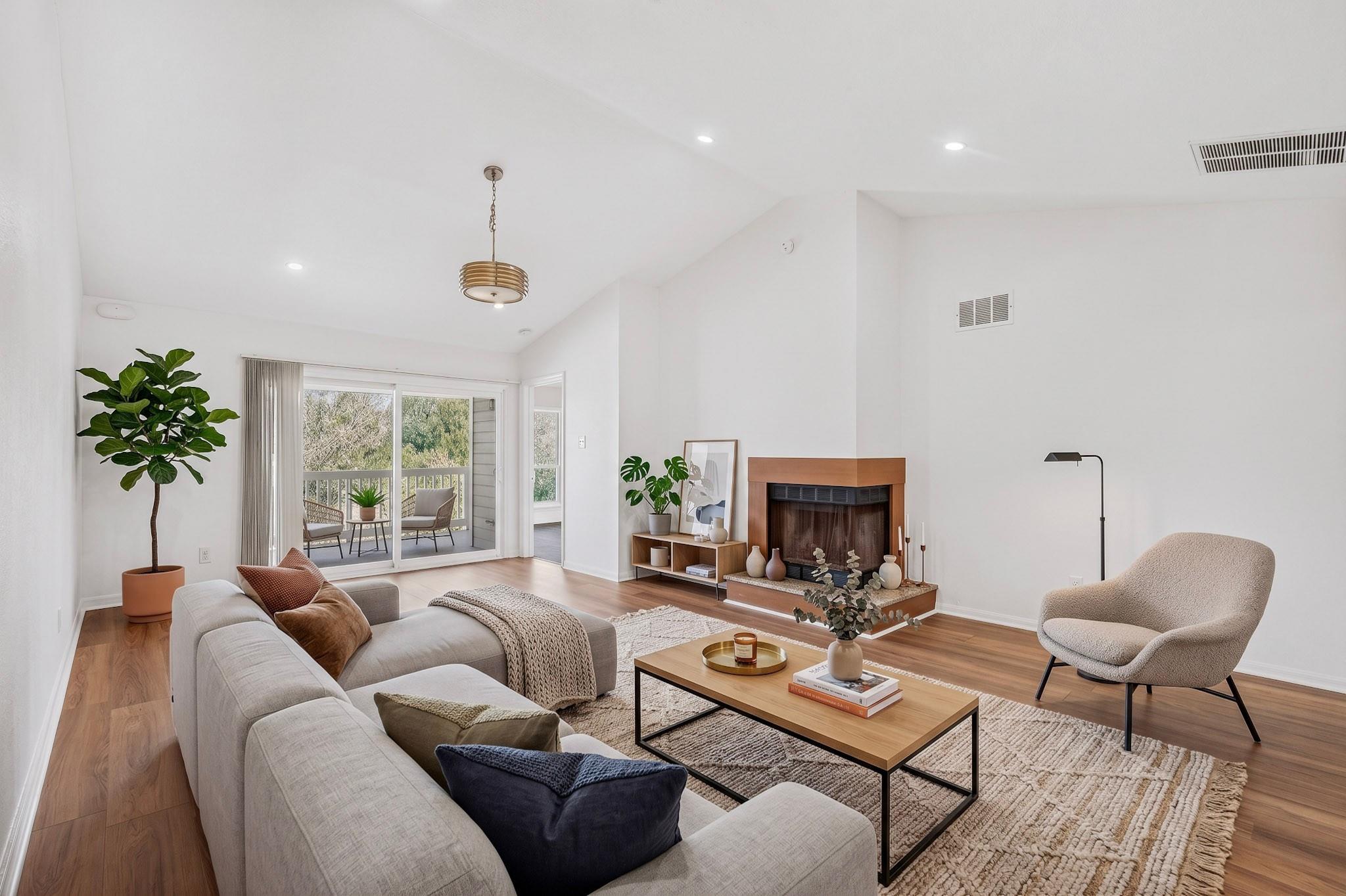 A corner fireplace and vaulted ceilings define th