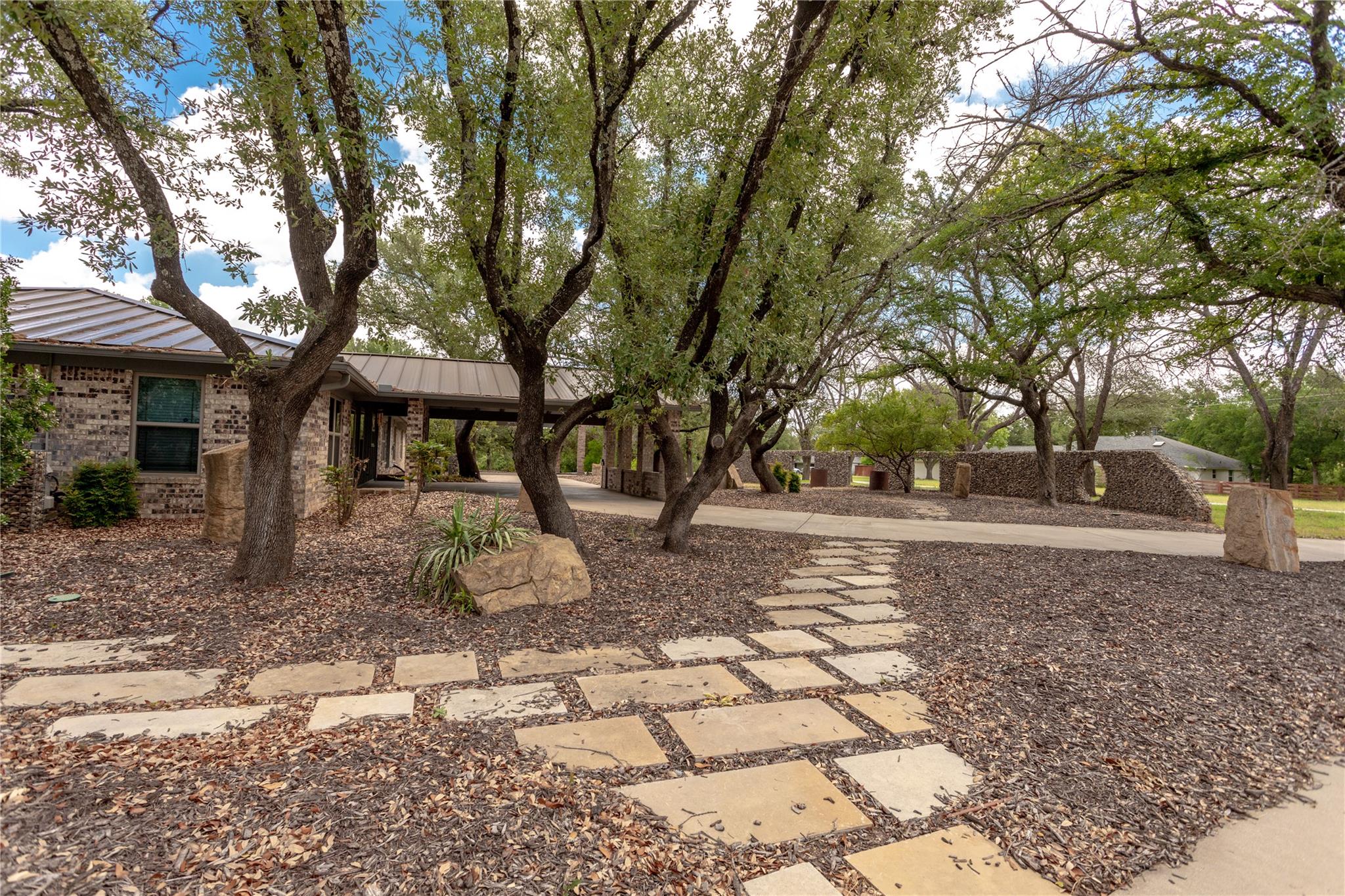 A flagstone path leads through a well-landscaped 