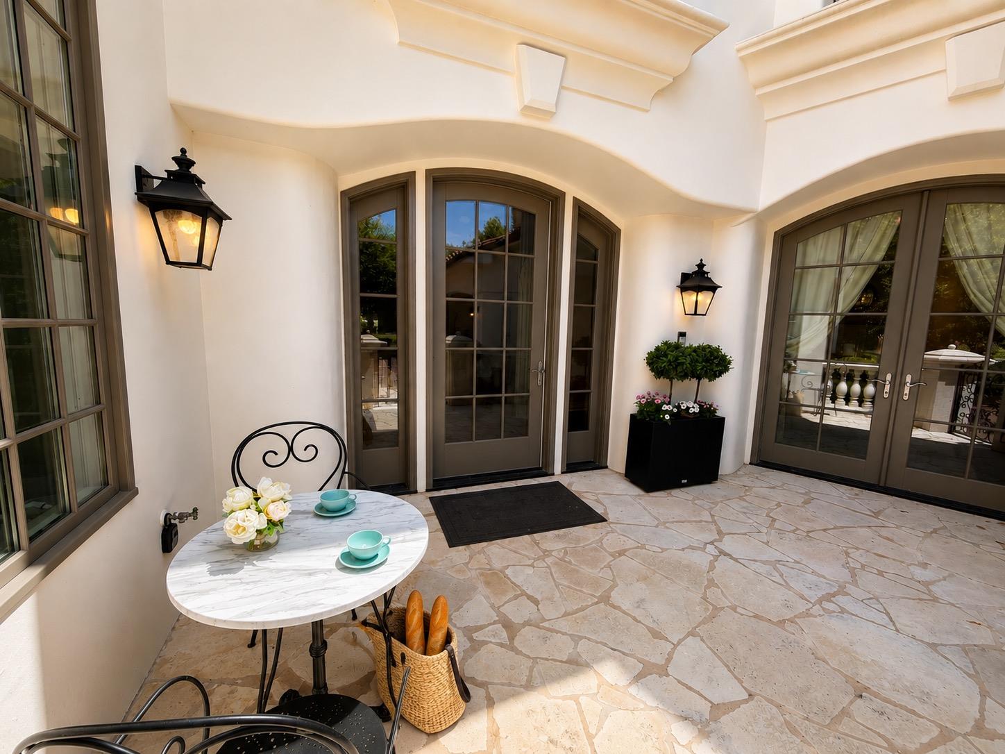 An inviting stone patio offers a secluded outdoor
