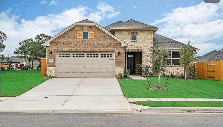 A classic brick and stone facade welcomes with a 