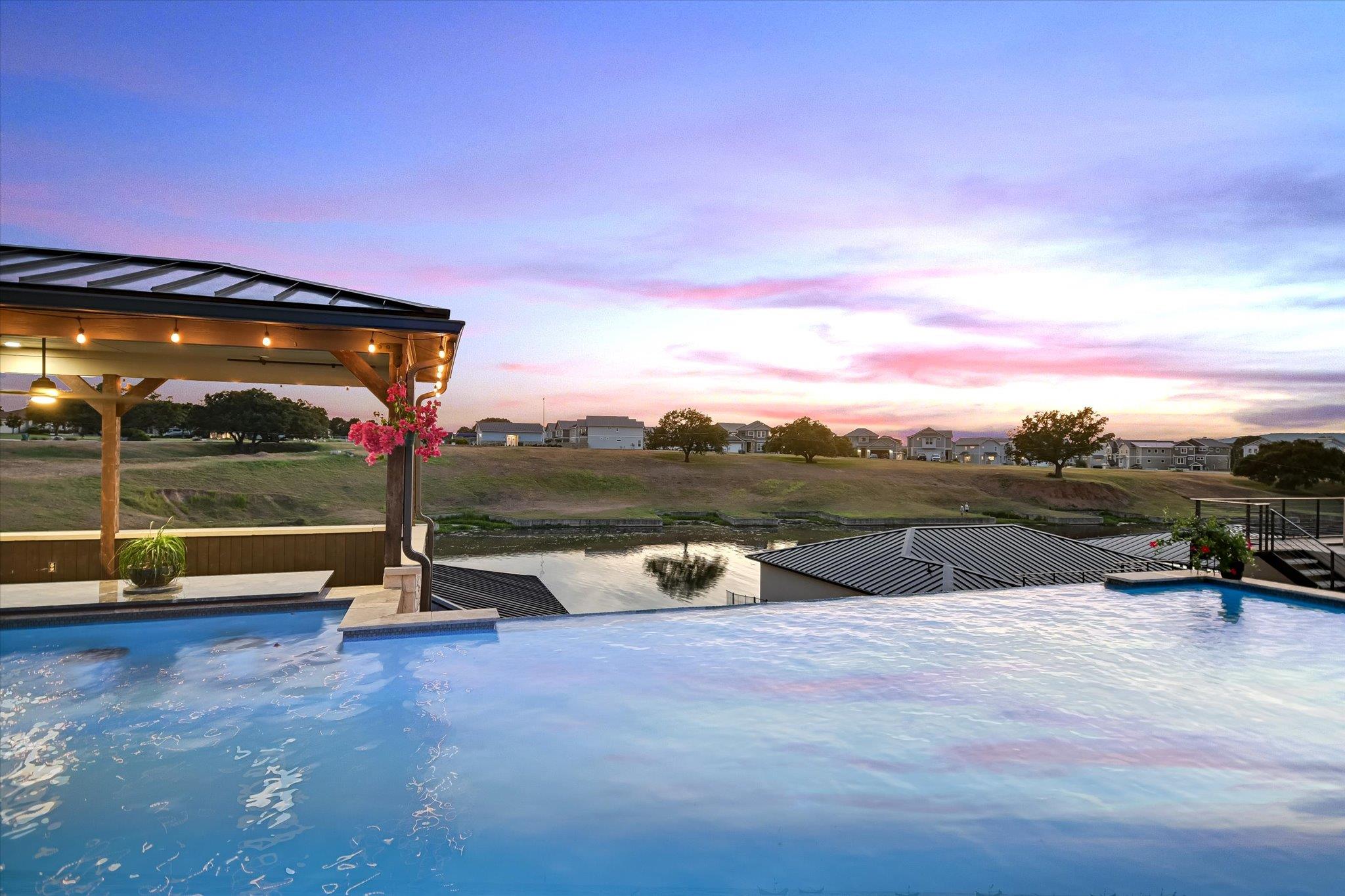 An inviting infinity-edge pool beckons under a vi