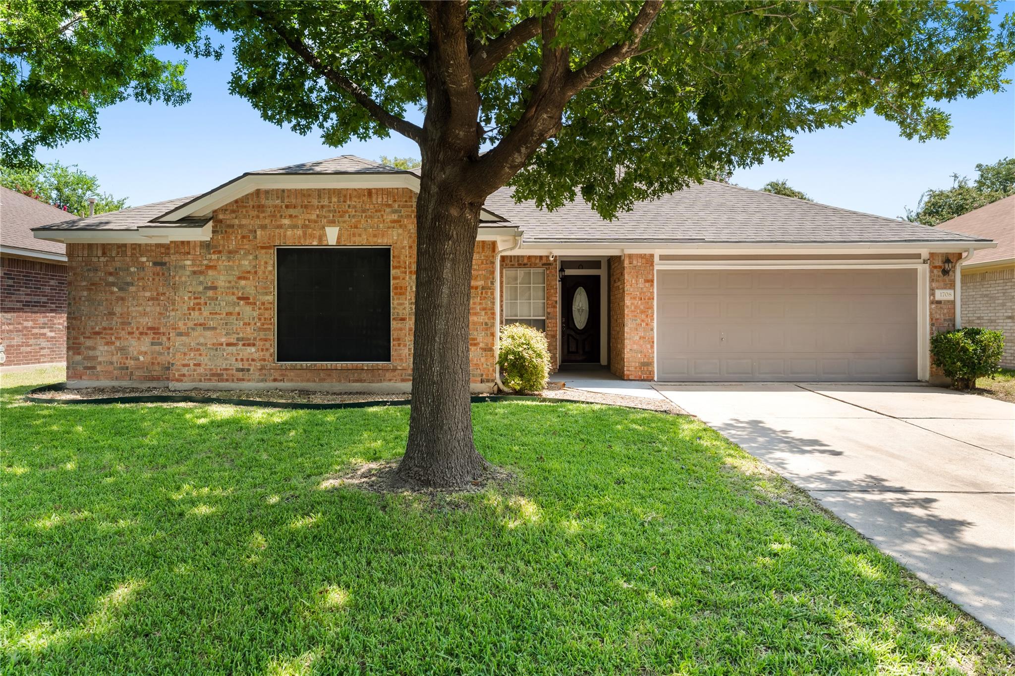 A classic brick facade welcomes you home, complem