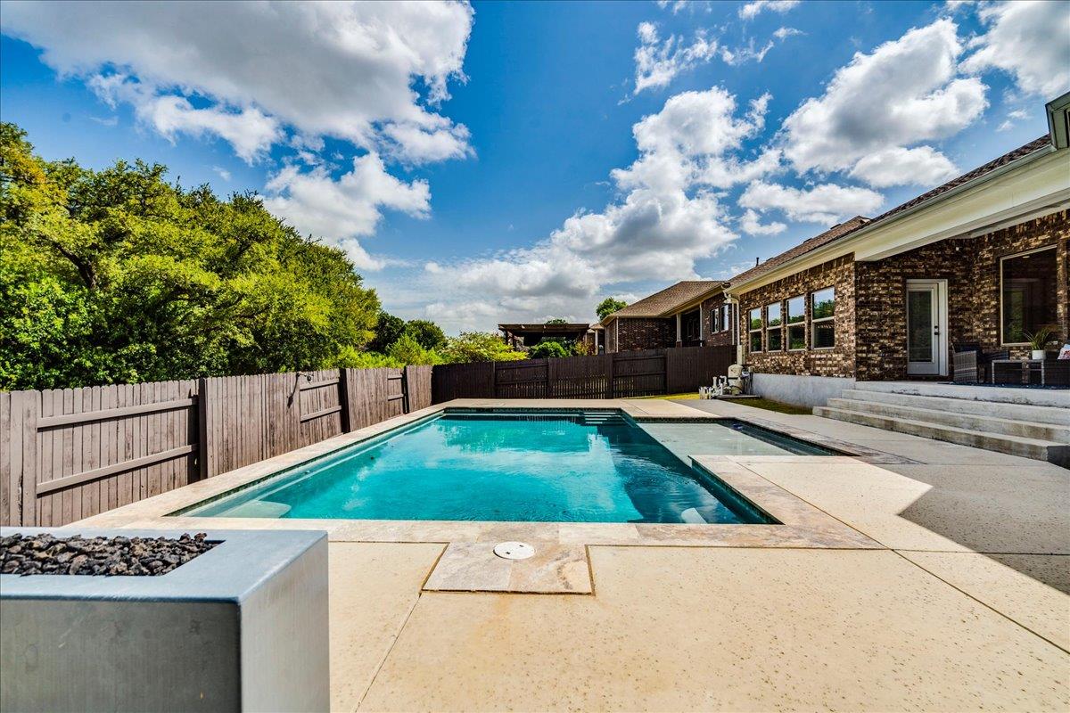An inviting backyard features a sparkling in-grou