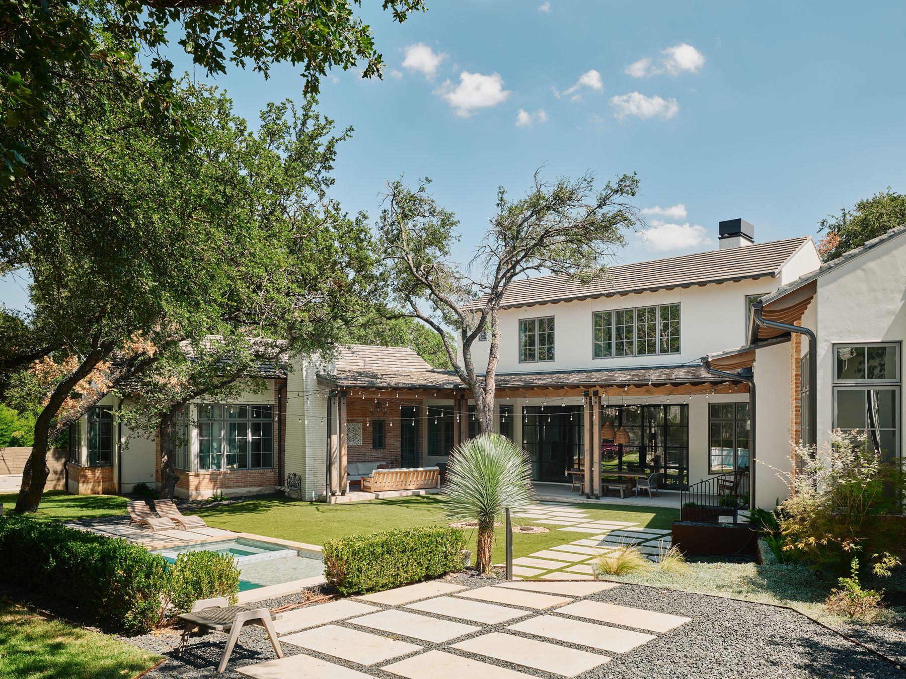 An inviting backyard oasis offers a serene pool, 