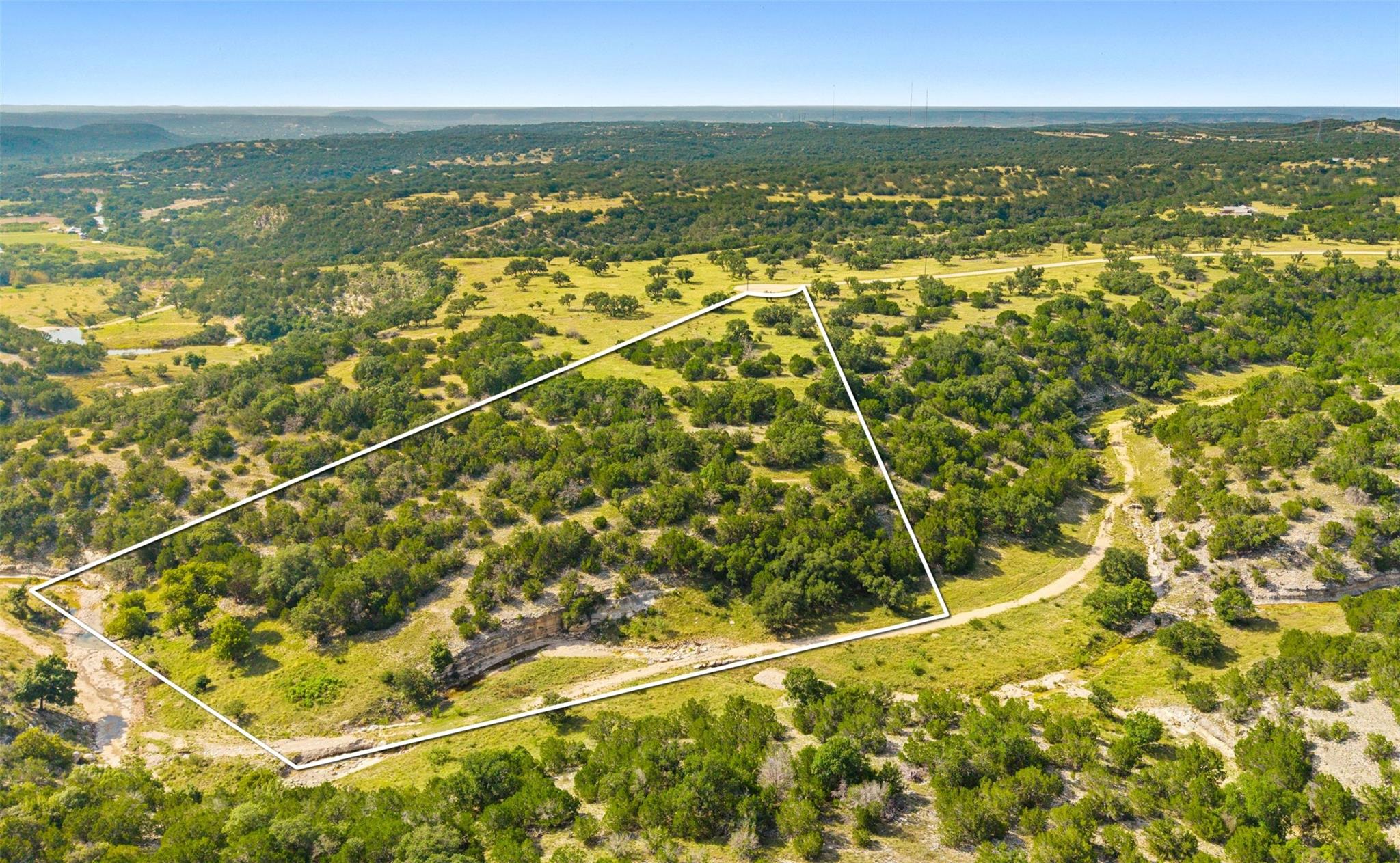 A sweeping aerial view showcases a verdant landsc