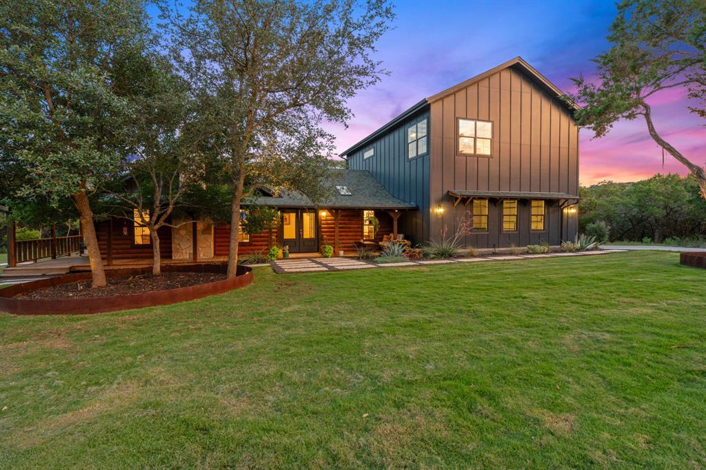 A striking modern farmhouse with traditional log 