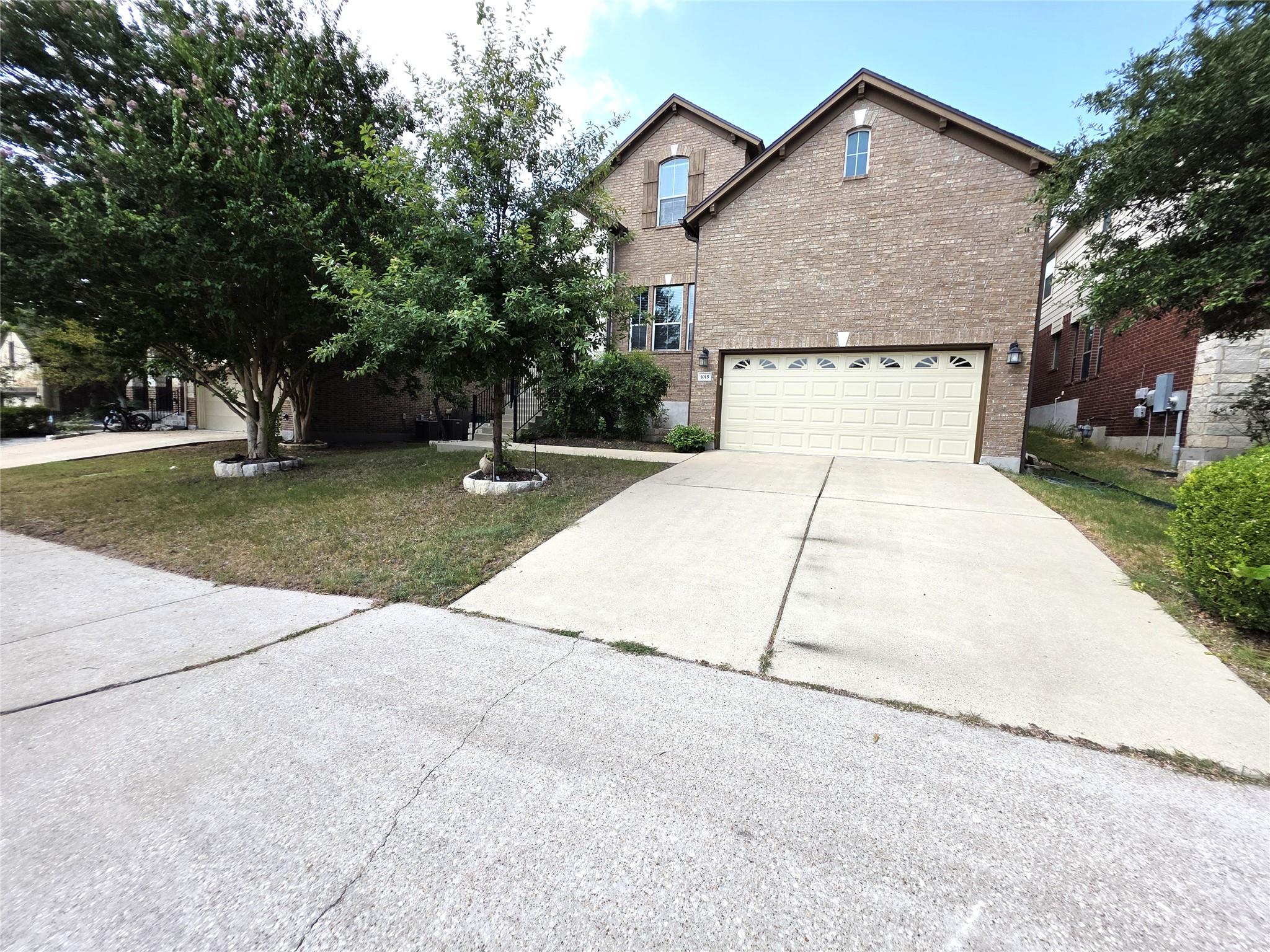 A well-maintained lawn and sturdy brick facade fr