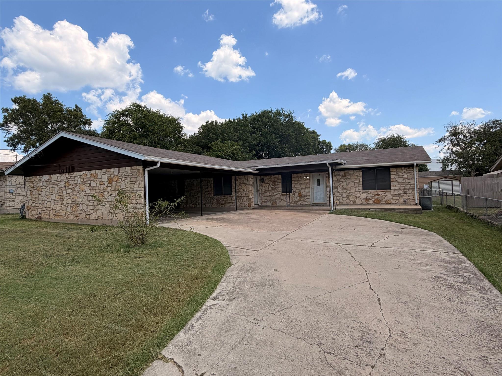 A well-maintained home featuring a carport and a 