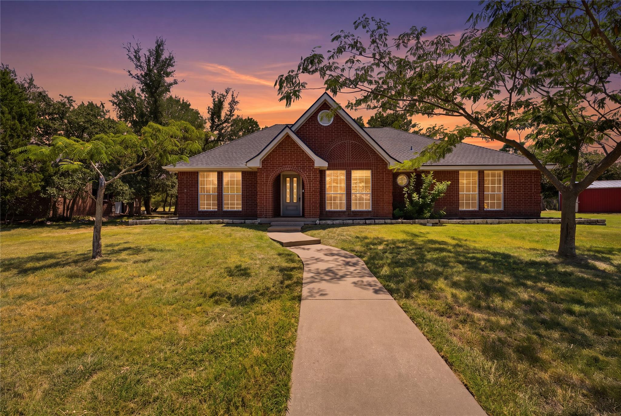 An inviting concrete walkway leads to the classic