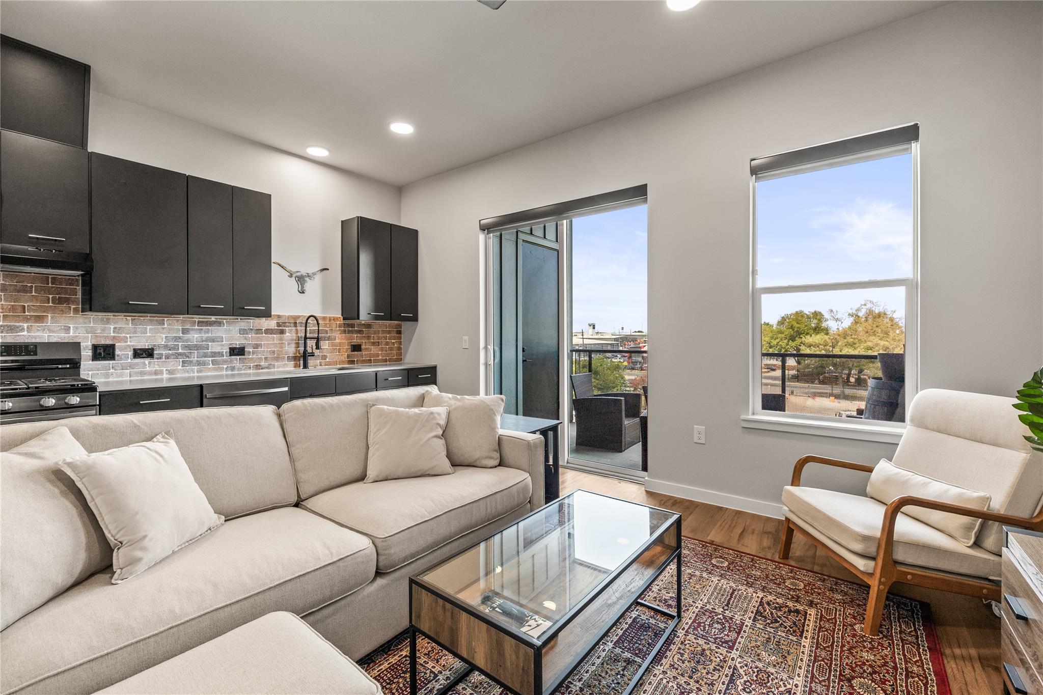 Hardwood floors and sliding glass doors open to a