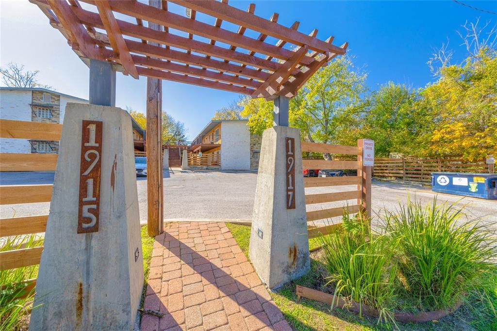 A charming wooden pergola entryway greets visitor