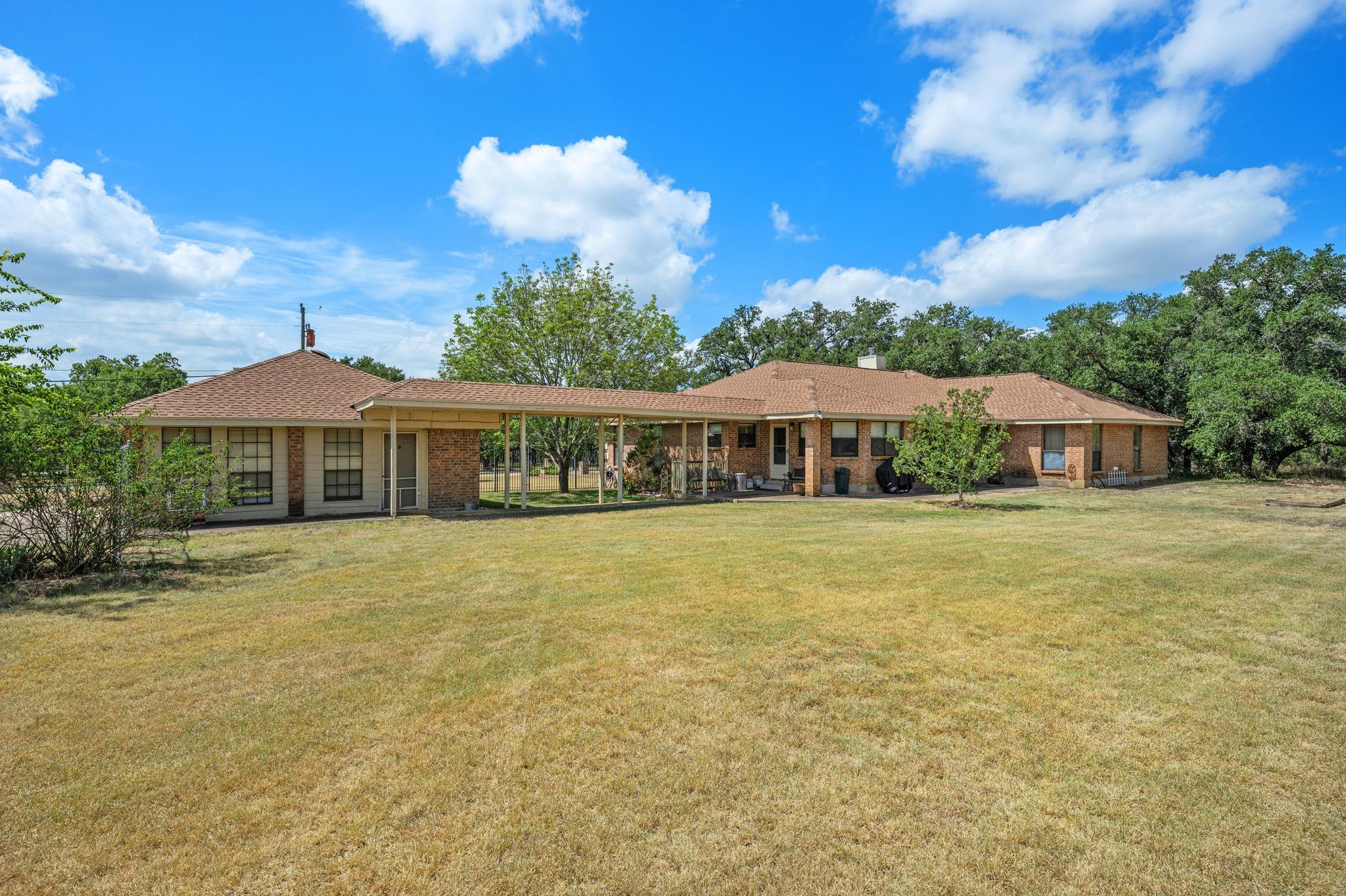 A spacious brick ranch home sits on a sprawling l