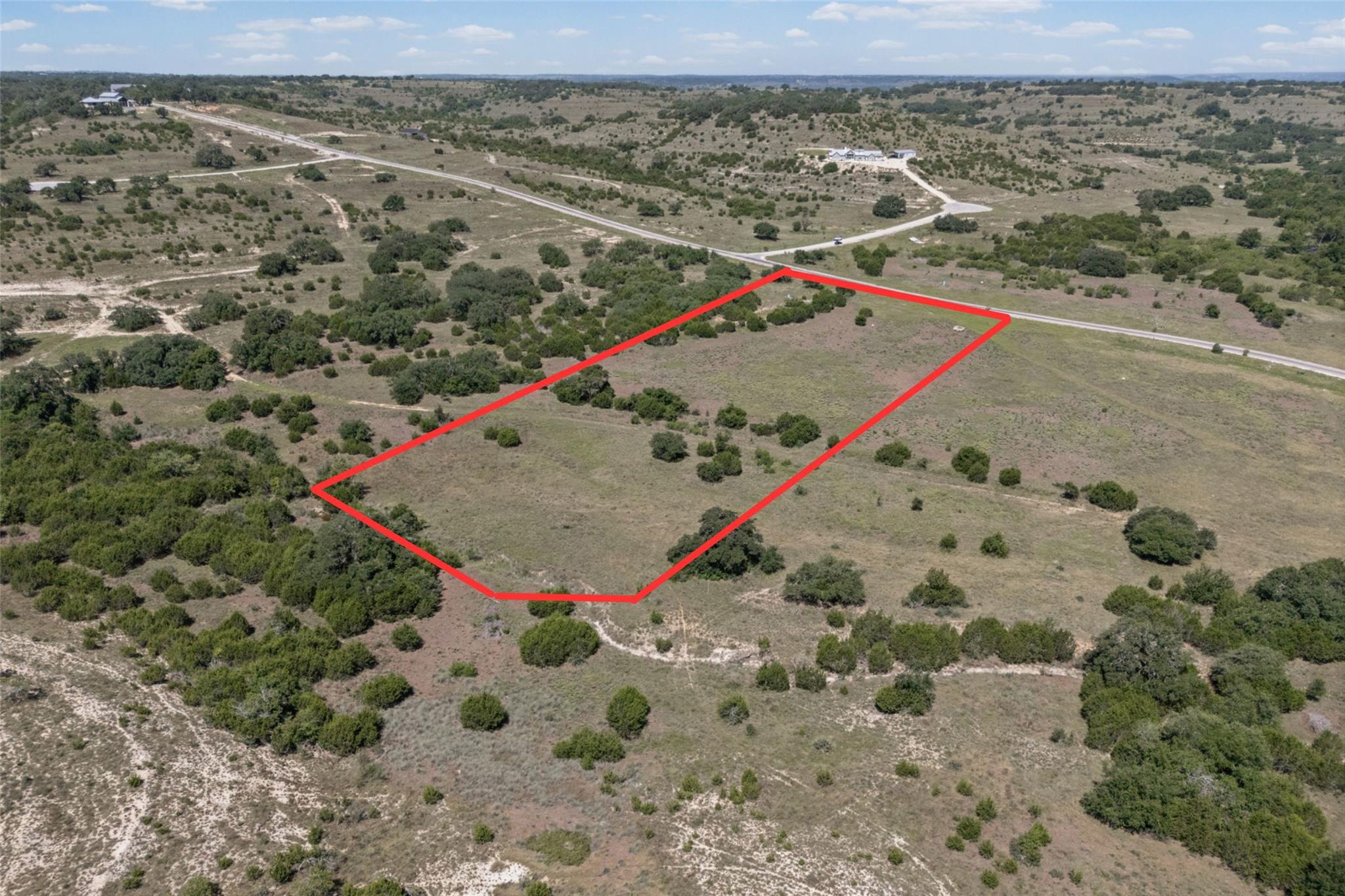 A sweeping aerial view showcases a vacant lot, of