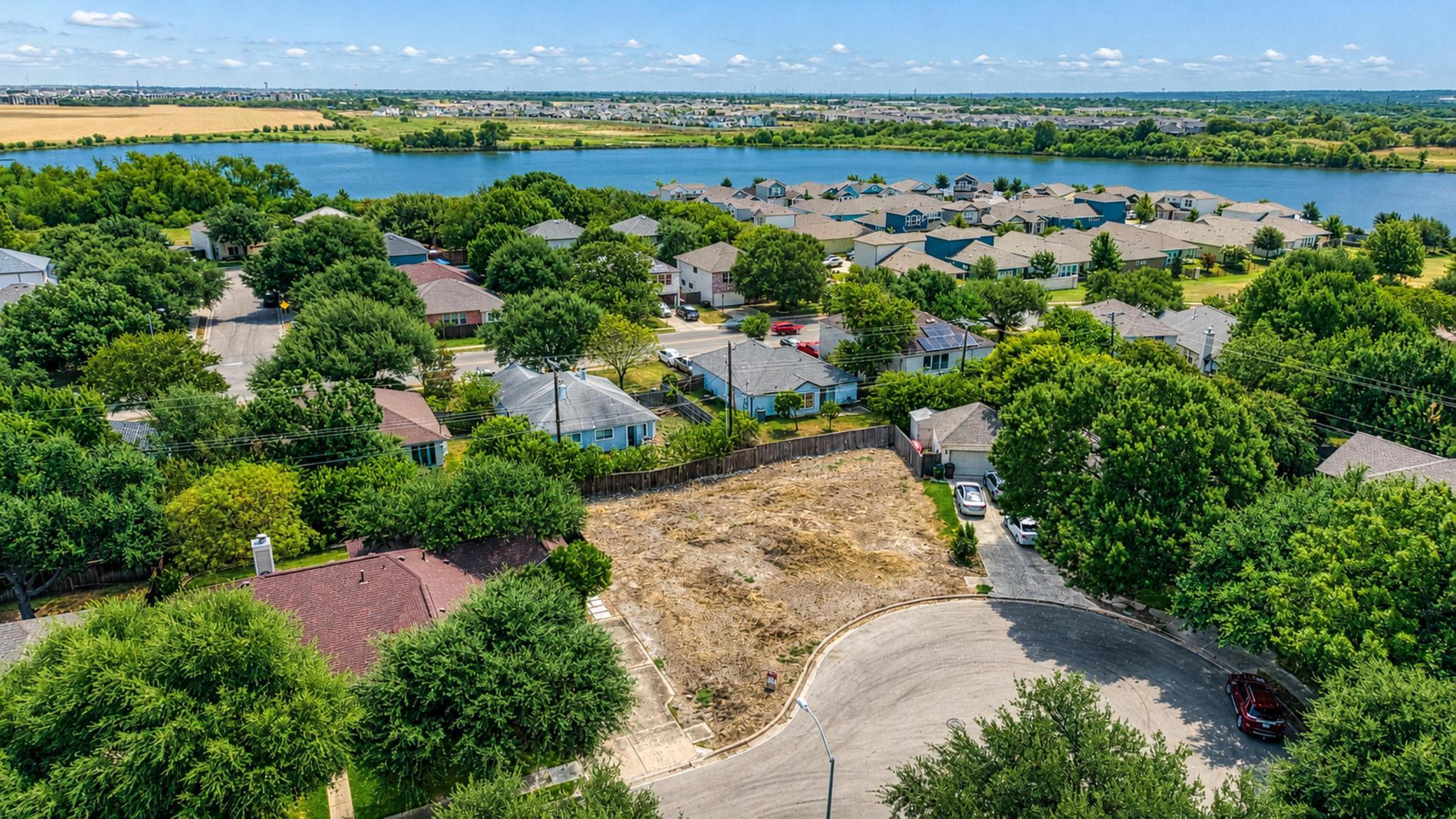 A vacant building lot sits tucked away at the end