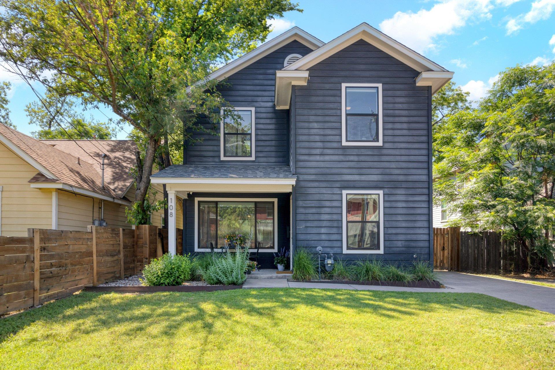 A dark-hued facade with crisp white trim stands o