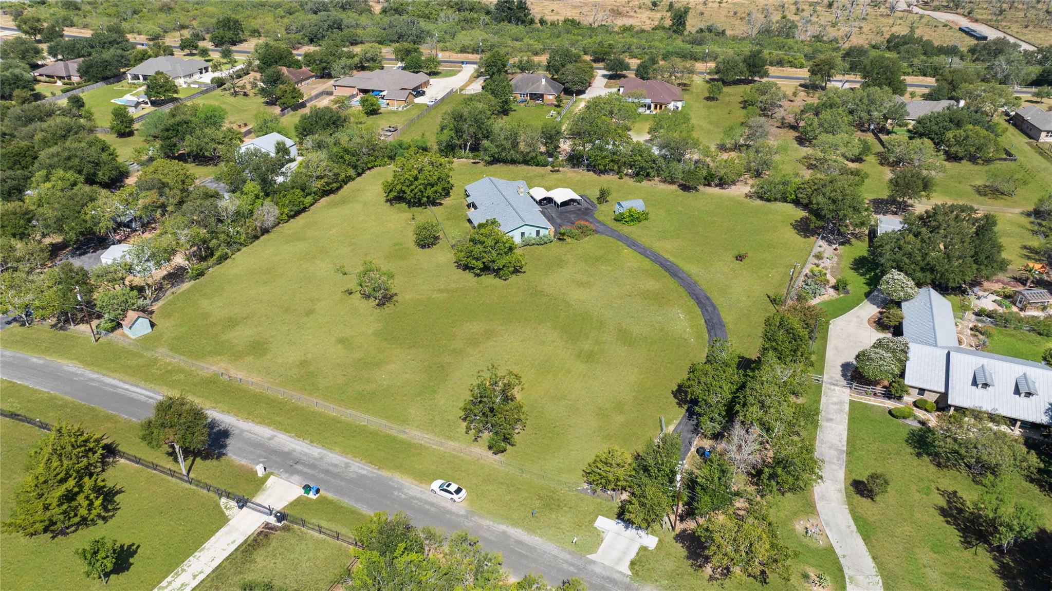 Sprawling green lawns surround this country homes