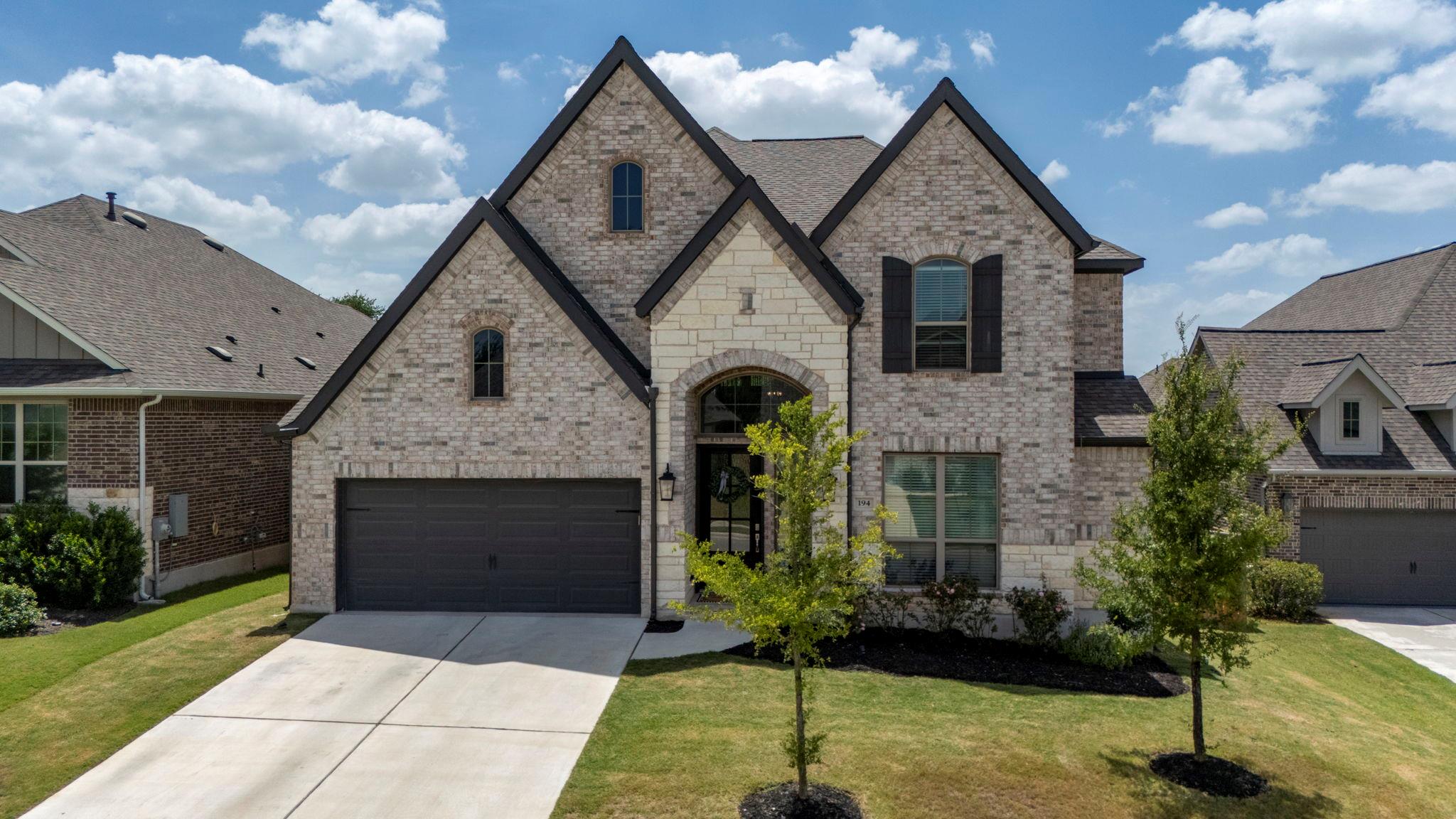 A striking home showcasing a classic brick and st
