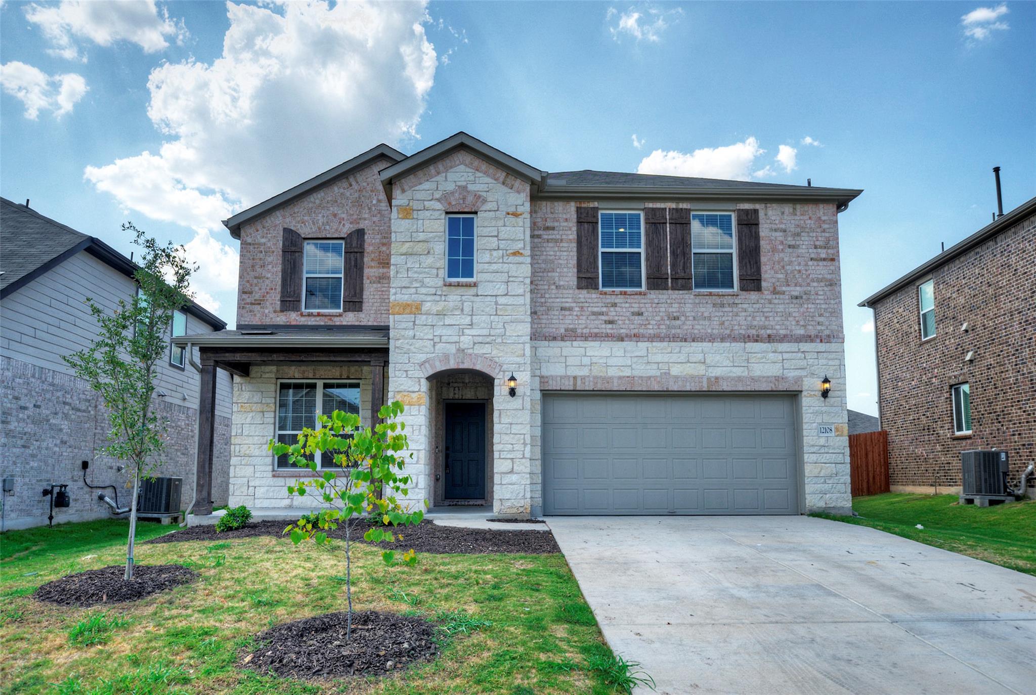 Textured stone accents and classic brickwork fram