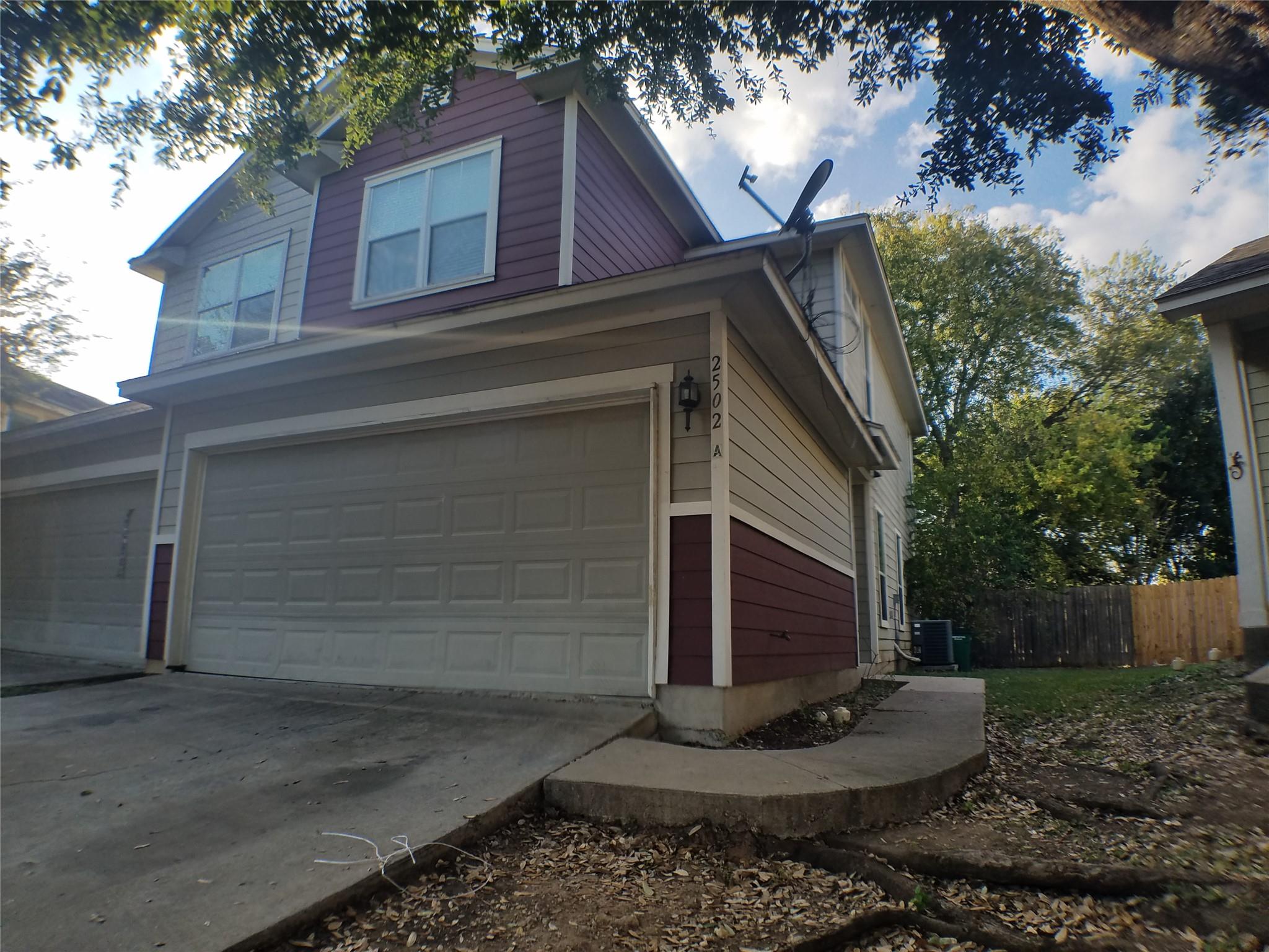 A charming exterior with dual garage doors and a 