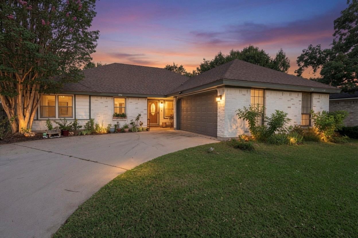 A graceful home with a curved driveway and neatly