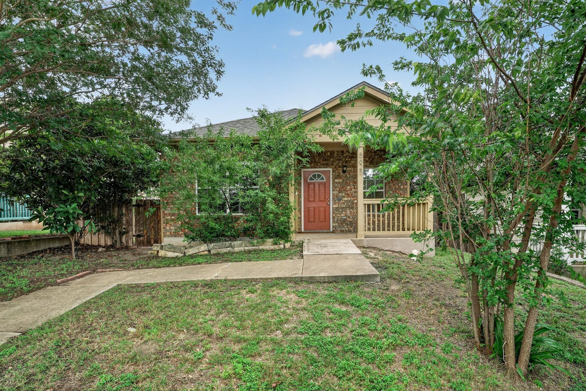 A welcoming front porch and mature landscaping en