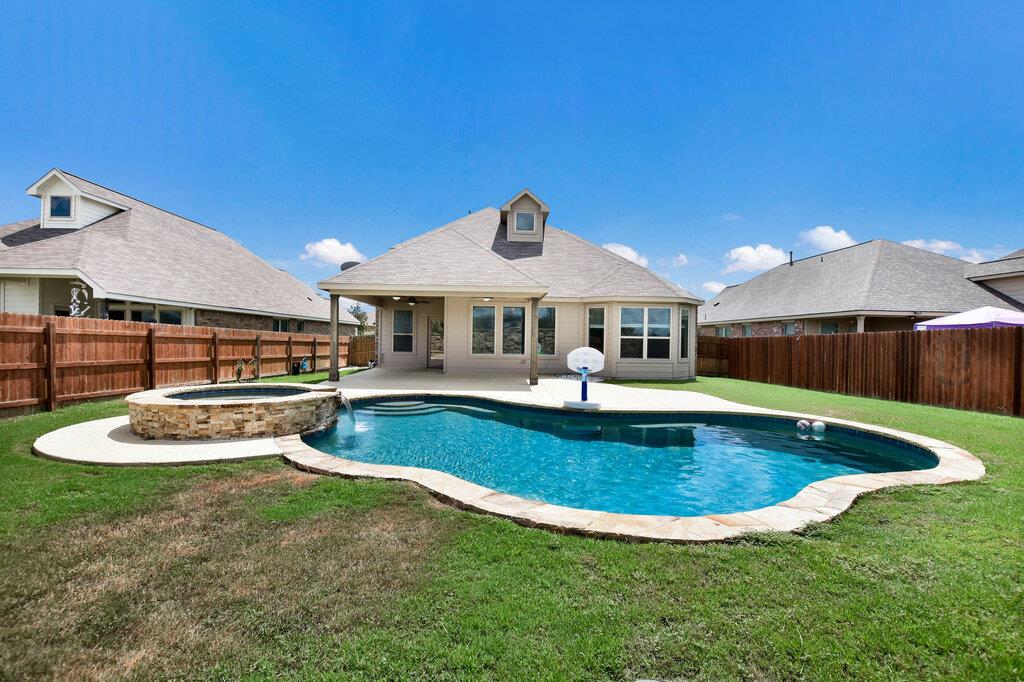 An inviting backyard oasis offers a sparkling in-