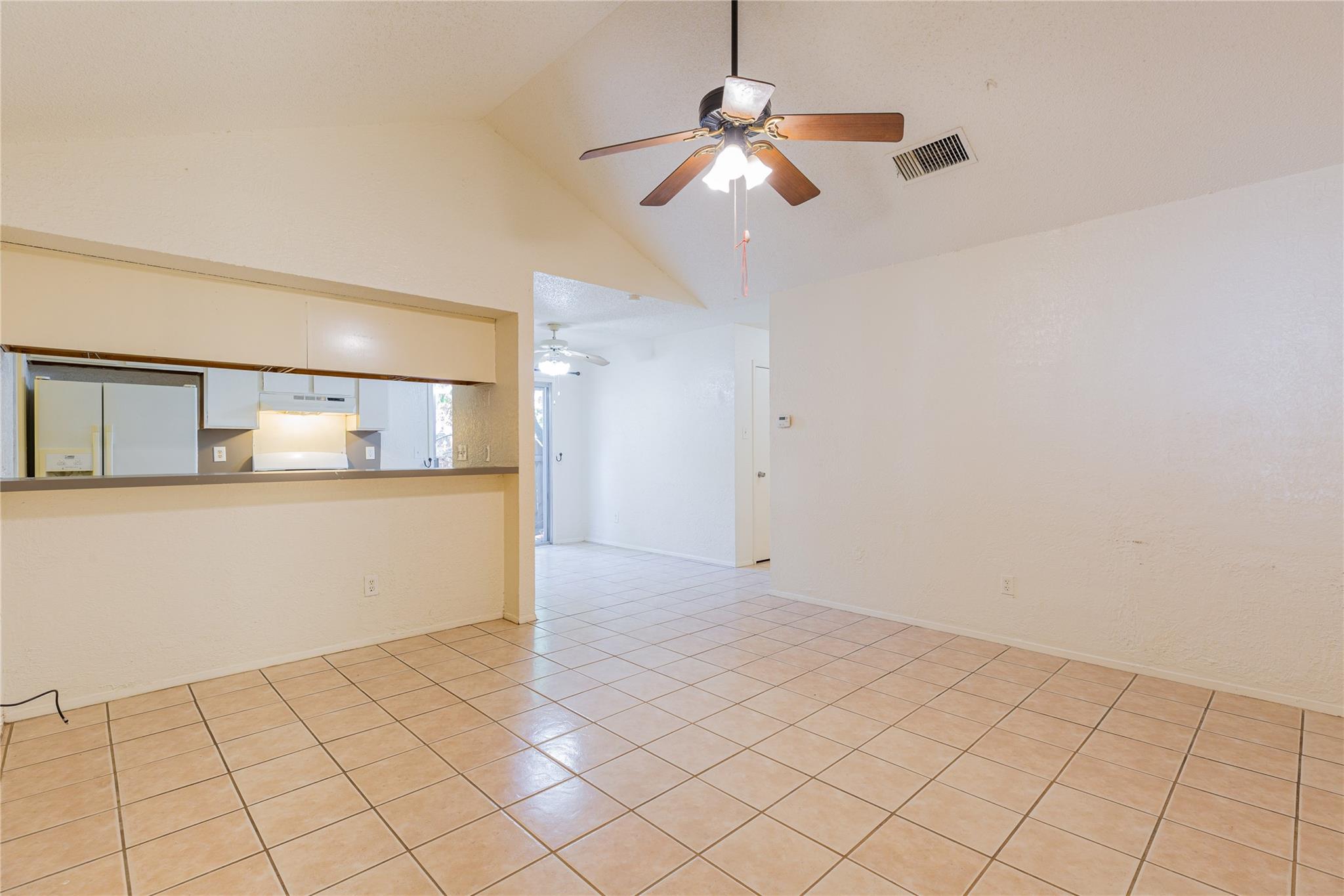 Vaulted ceilings and tile flooring enhance this o