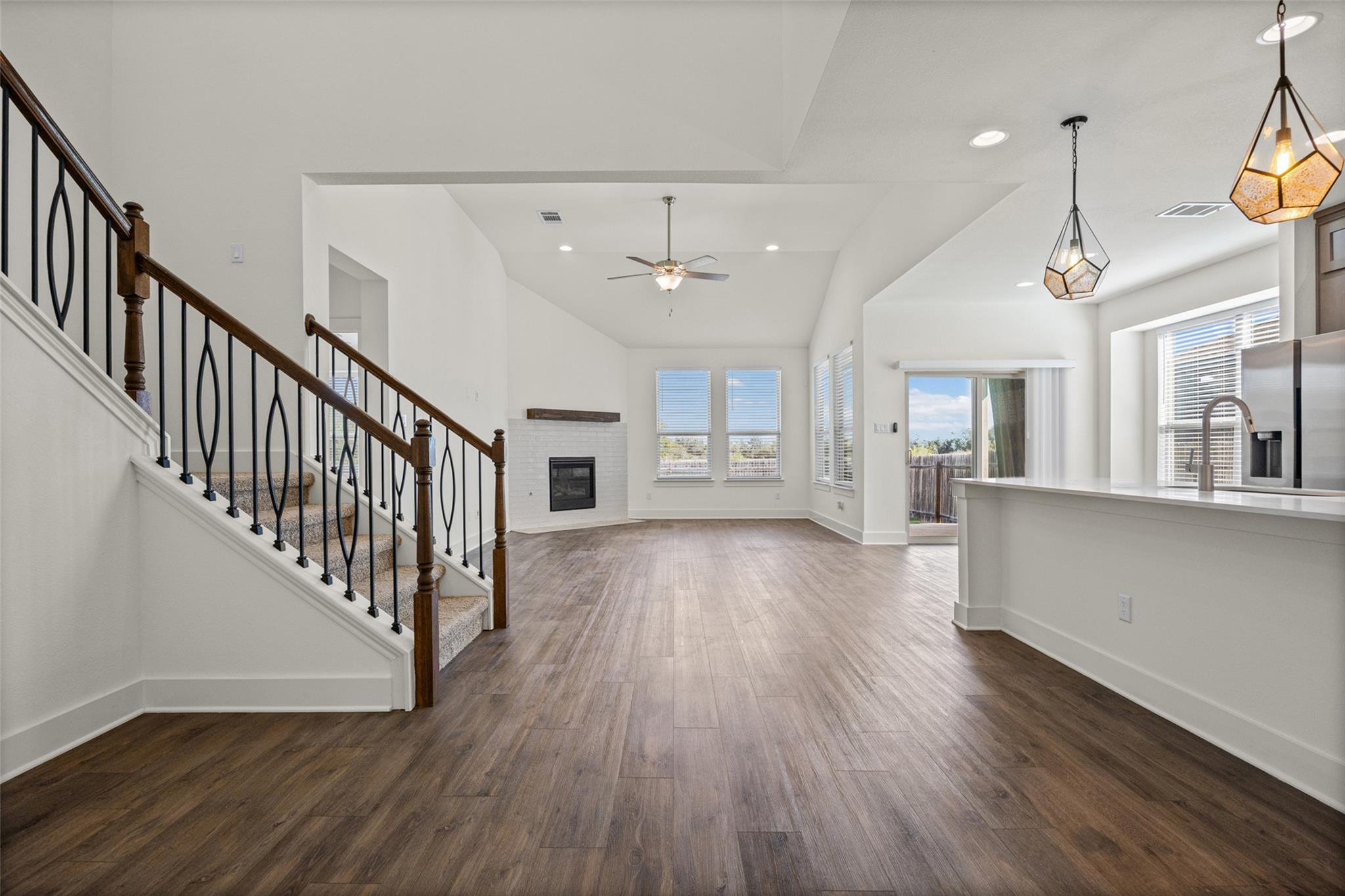 Polished wood-look flooring and soaring vaulted c