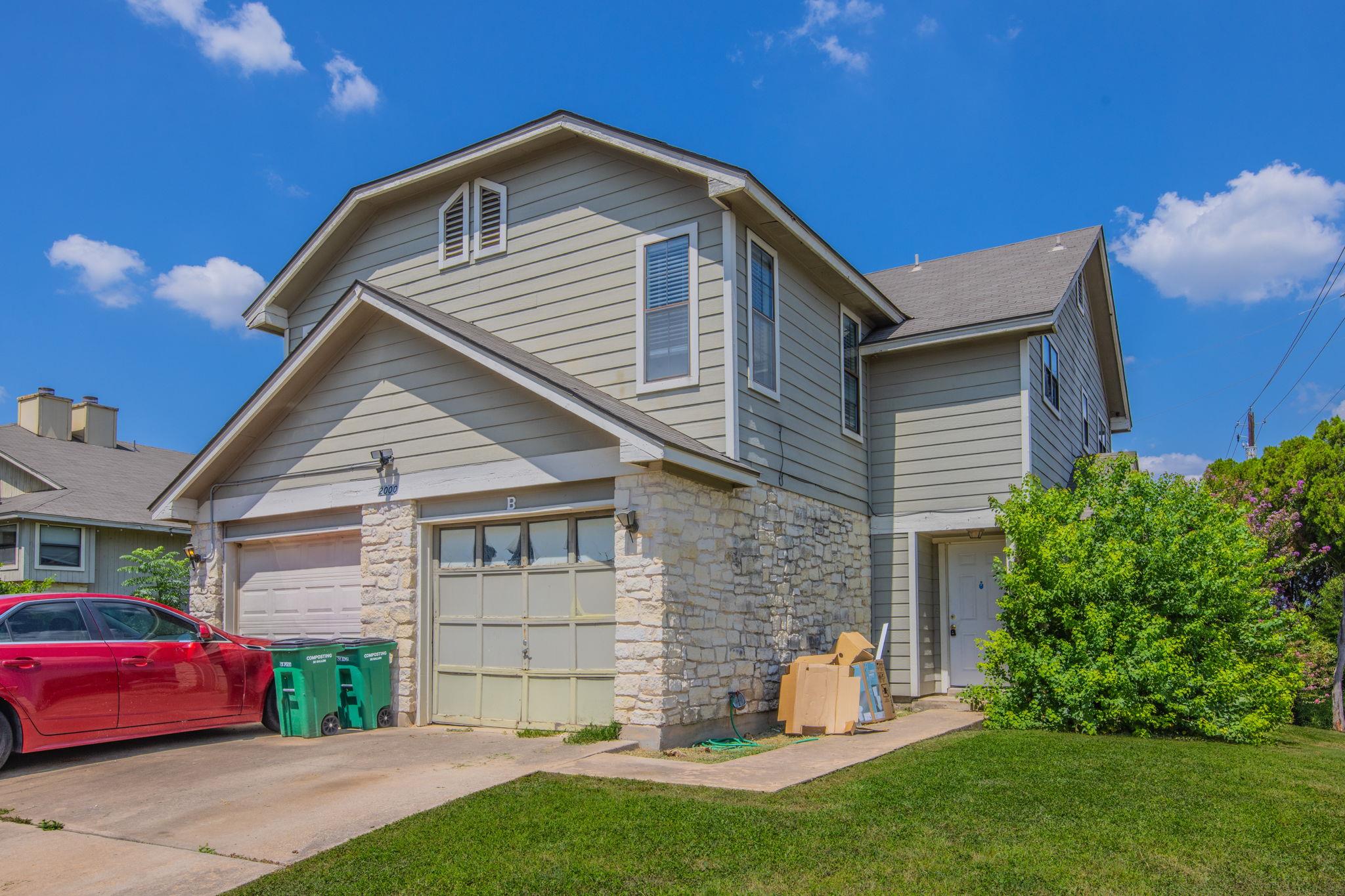 Well-maintained siding and a concrete driveway de
