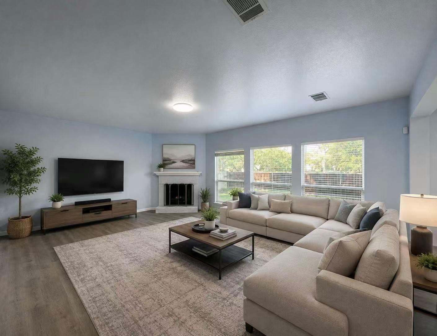 A well-lit living area showcases a corner firepla