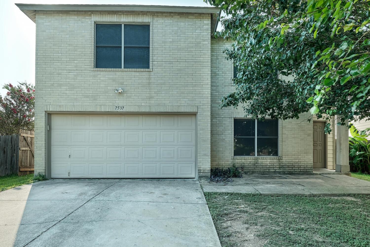 A classic brick facade with an attached garage an