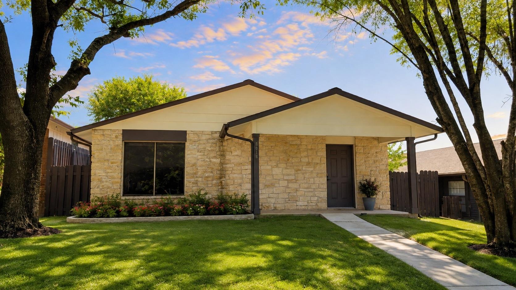A charming single-story home with a stone facade,