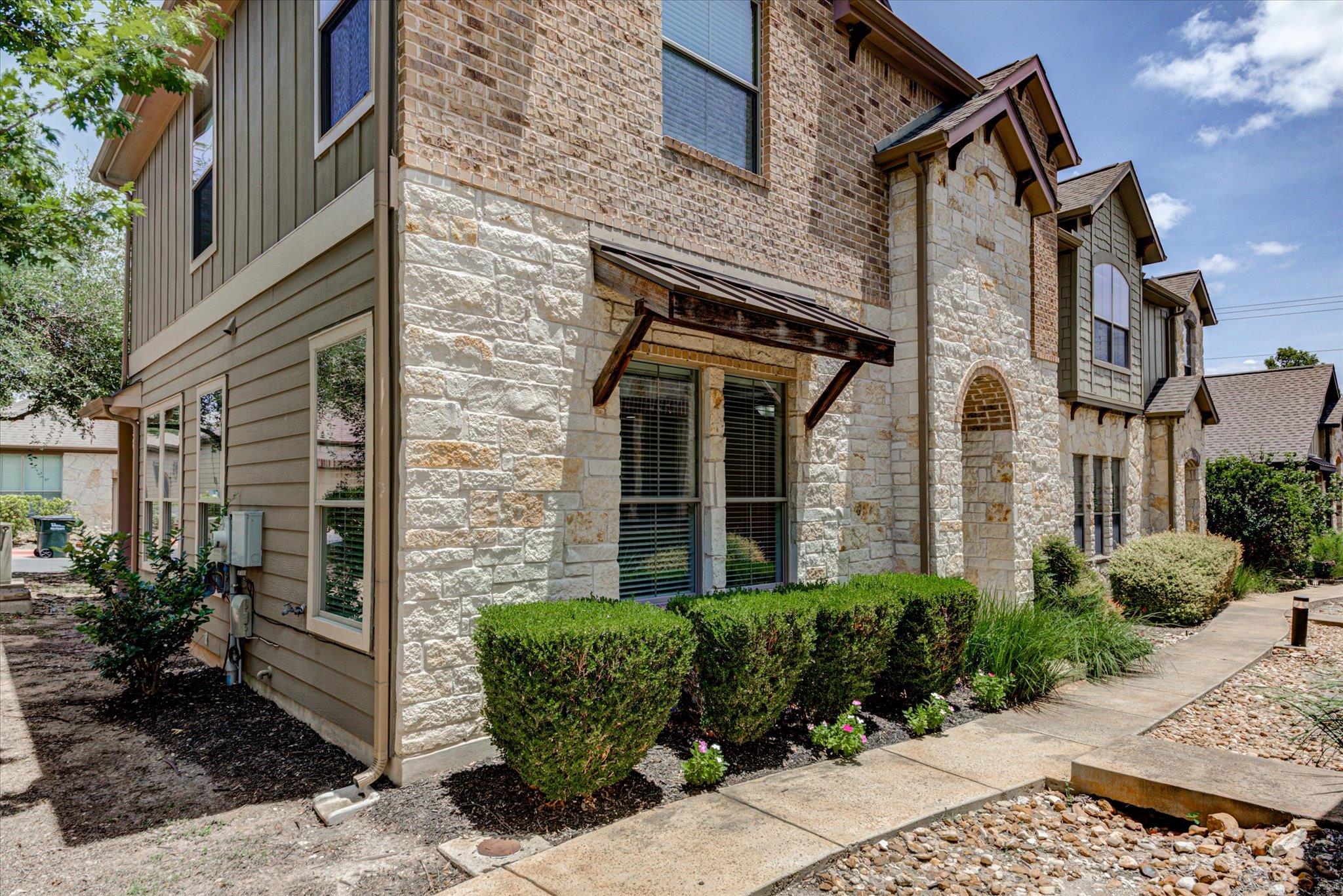 A charming facade combines stone and brick with a