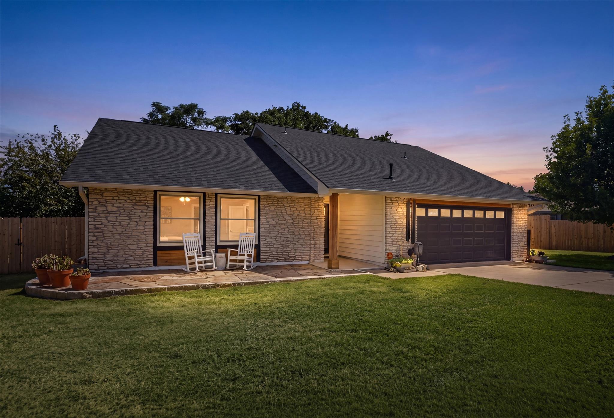 Natural stone accents and wood siding define the 