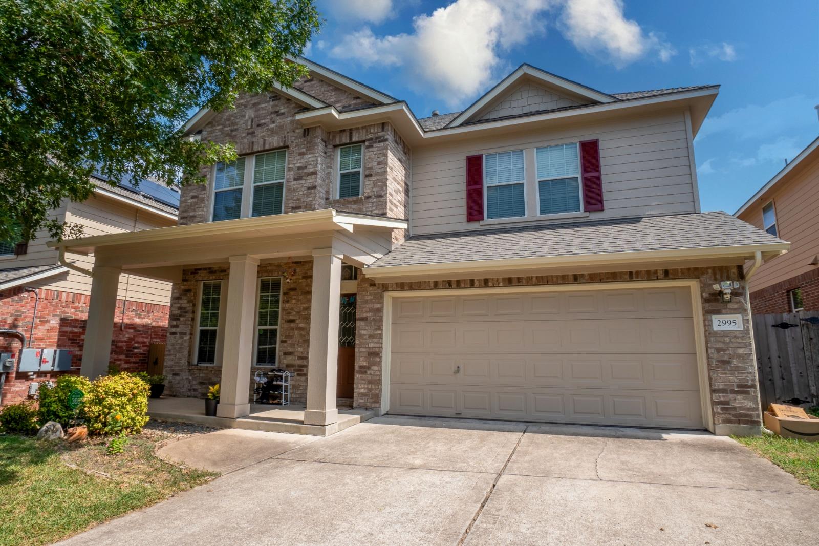 A classic brick and siding two-story home feature