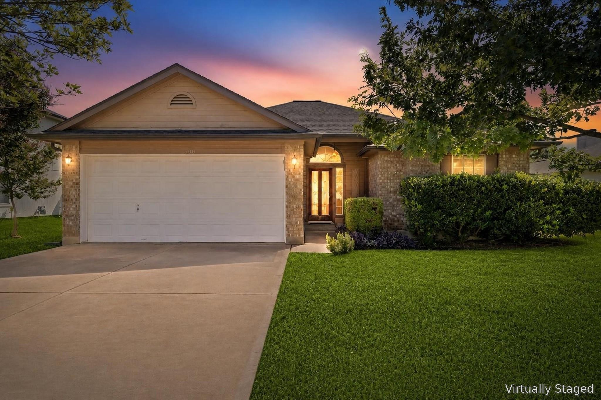 An inviting front facade features a welcoming ent