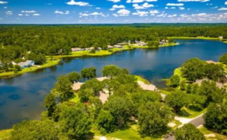 An aerial panorama reveals a serene lakeside comm