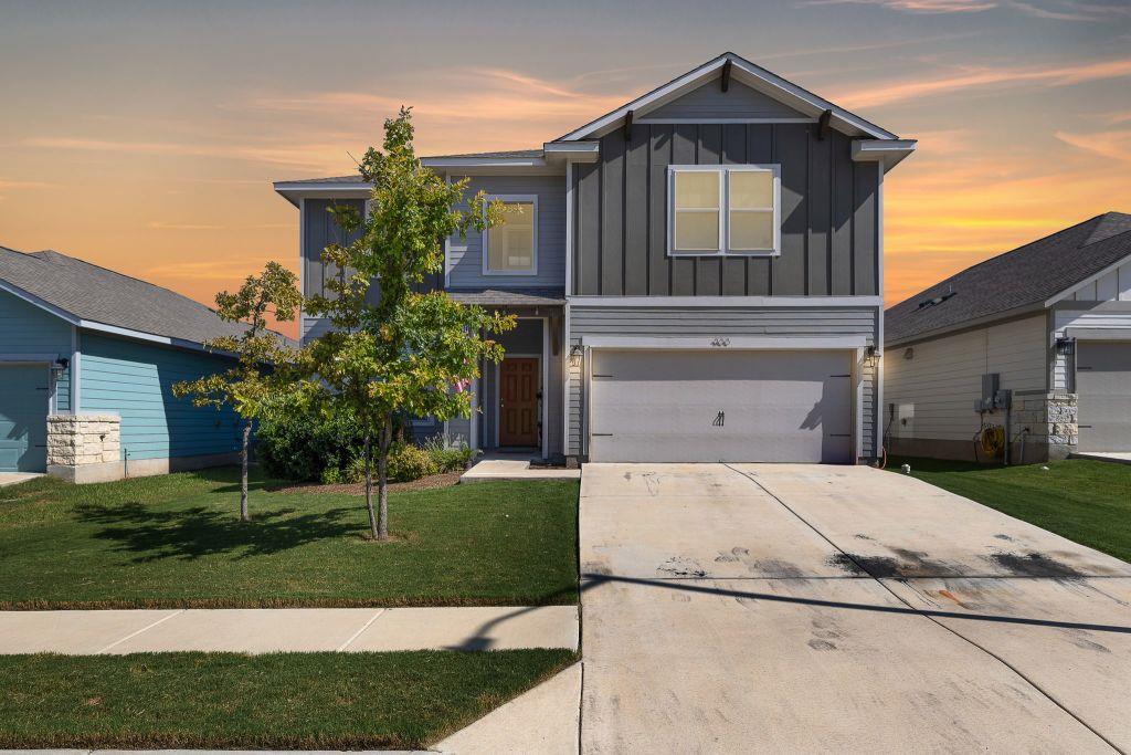 A well-maintained lawn and sturdy driveway welcom