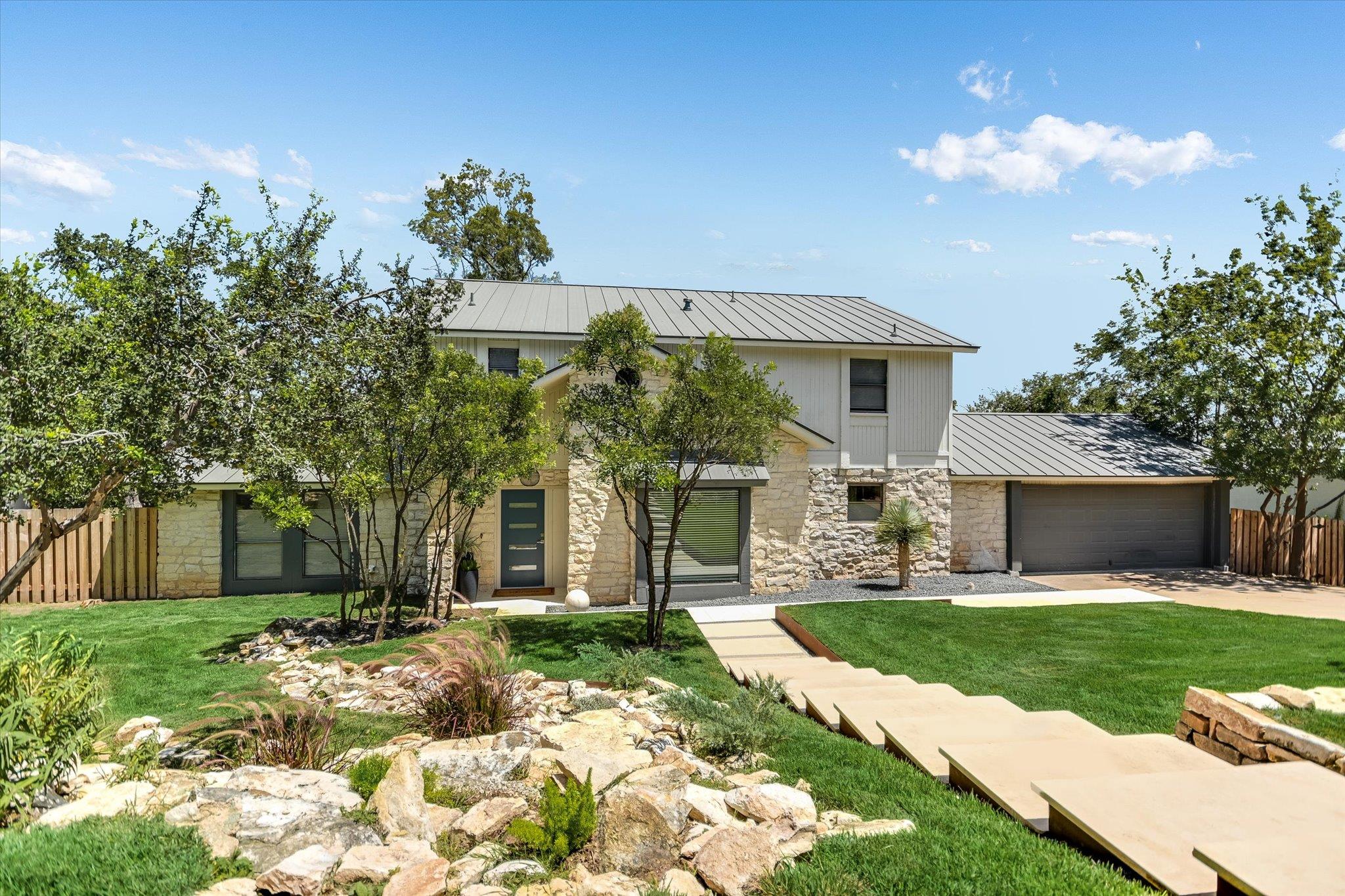 A modern two-story exterior pairs limestone sidin