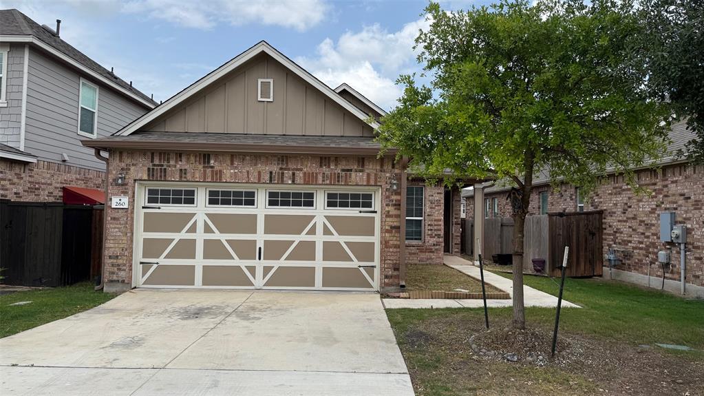 A classic brick exterior with a decorative garage