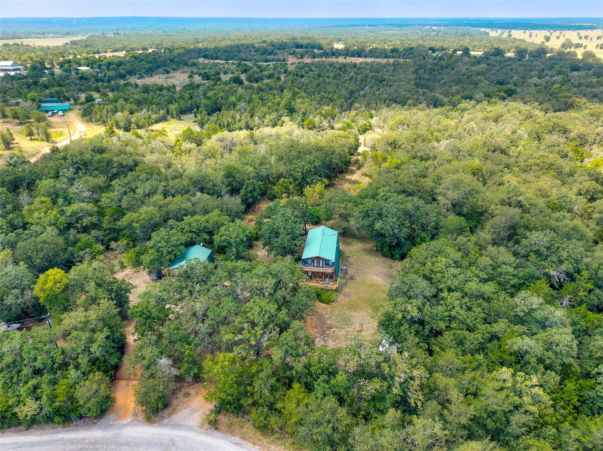 Nestled amidst verdant woodlands, this private re