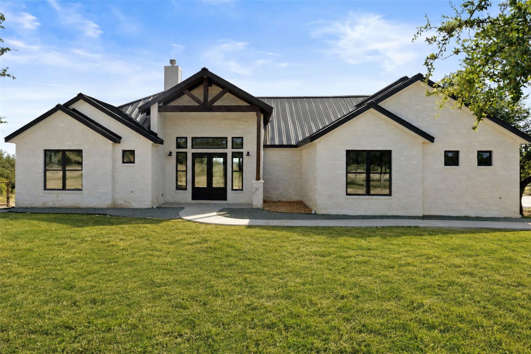 A modern farmhouse exterior with clean lines, a m