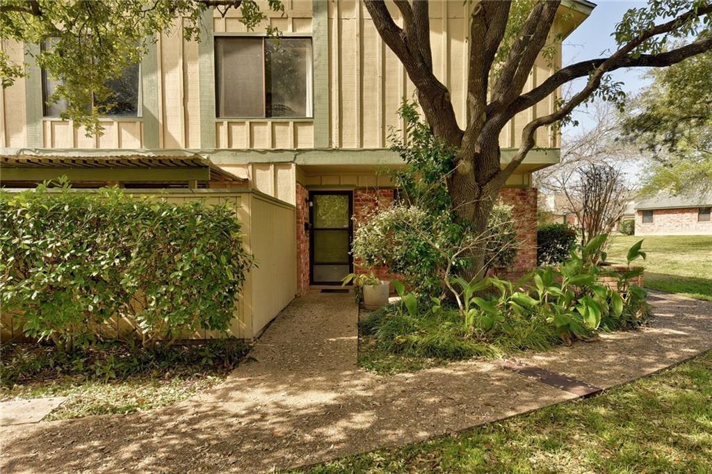 A welcoming front entrance, surrounded by lush la