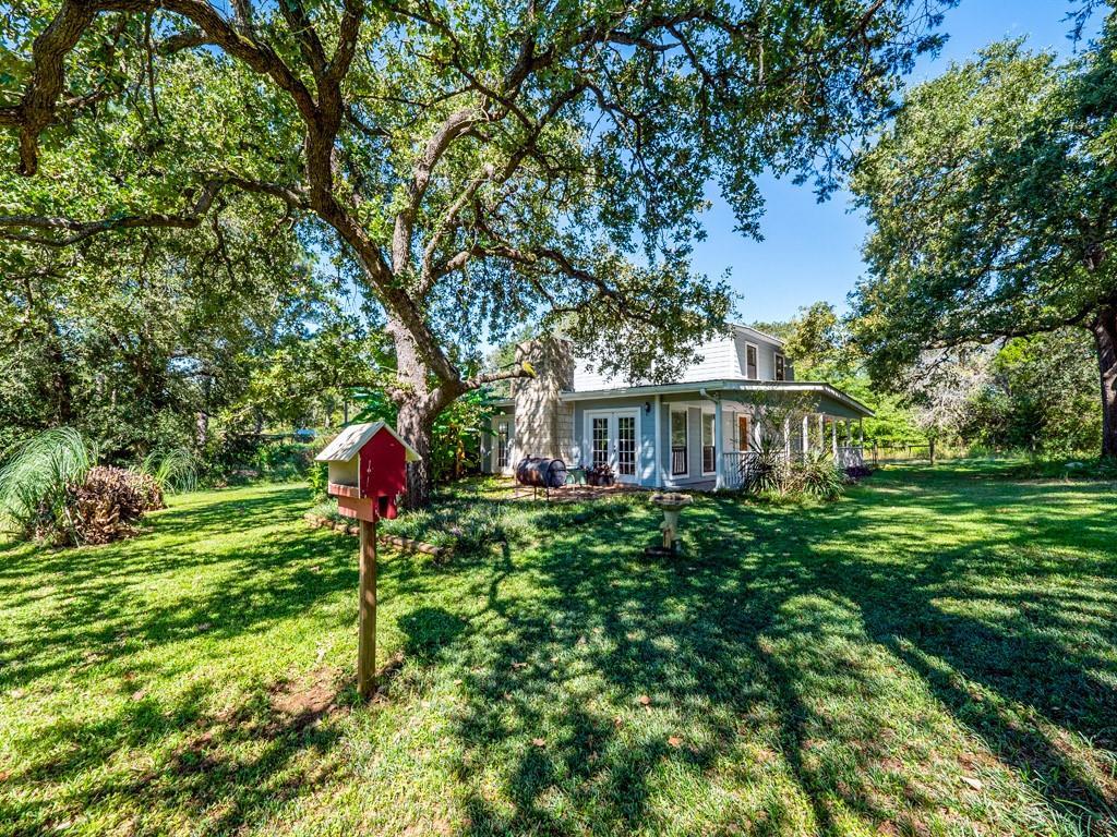 Mature trees shade this charming residence, offer