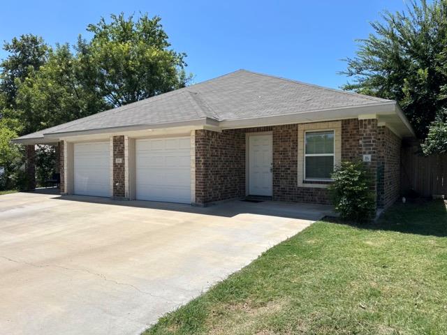 A well-maintained brick duplex with an attached t