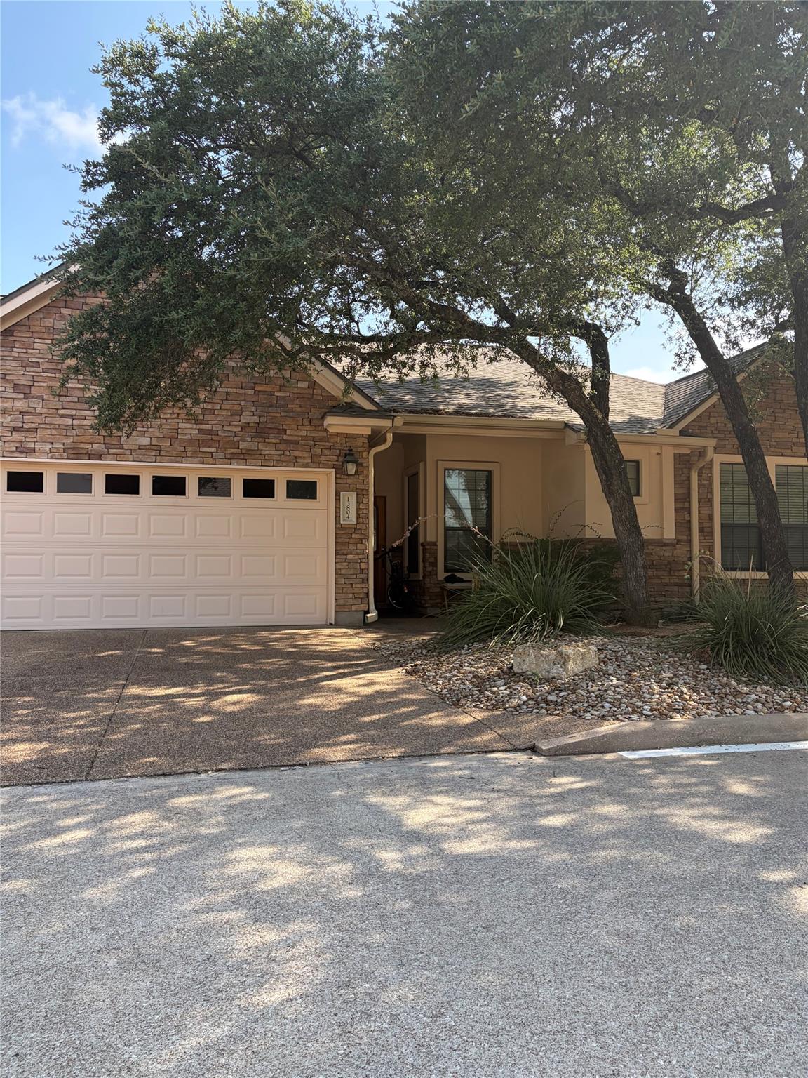 Mature trees frame this charming residence, offer