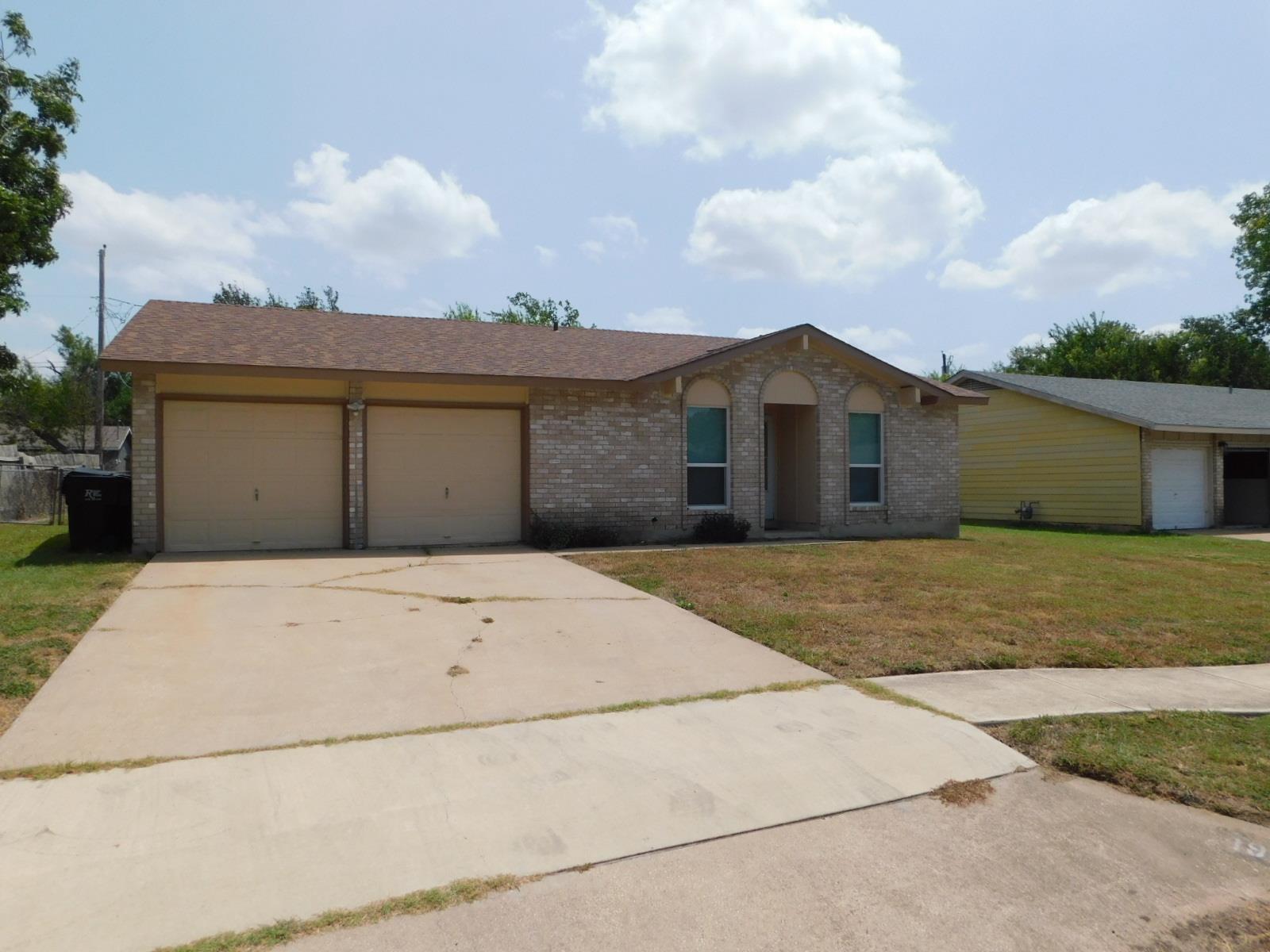 A well-maintained brick facade home awaits, featu